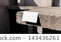 Blank white business card mockup resting on the edge of a raw concrete slab outdoors with business concrete architecture industrial sunlight presentation stationery branding identity template 143436261