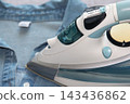 Close-up of a modern steam iron pressing a blue shirt, highlighting fabric care, wrinkle removal and household appliance use. 143436862