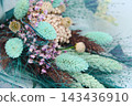 Close-up of an elegant dried flower bouquet in turquoise, green, and purple tones, idea for wedding and greeting cards, floral design, and background 143436910