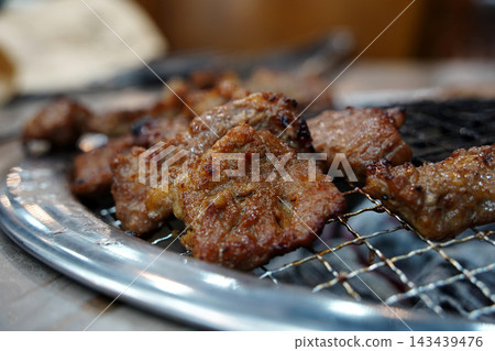 Korean BBQ Marinated Pork Ribs Galbi Grilling on Charcoal Mesh Korean BBQ Marinated Pork Ribs Galbi Grilling on Charcoal Mesh 143439476