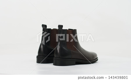Pair of brown leather chelsea boots for men showing elegant modern footwear style on white background 143439801