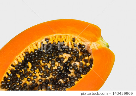 Half of ripe papaya fruit with seeds isolated on white background. Half of ripe papaya fruit with seeds isolated on white background. 143439909