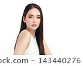A beautiful young Asian woman with clean, fresh skin against a white background. Skincare, facial treatment, cosmetology, beauty, and spa. An elegant portrait of an Asian woman. 143440276