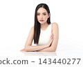A beautiful young Asian woman with clean, fresh skin against a white background. Skincare, facial treatment, cosmetology, beauty, and spa. An elegant portrait of an Asian woman. 143440277