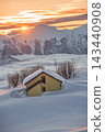 Yellow house almost buried in deep snow at mountain sunset Yellow house almost buried in deep snow at mountain sunset 143440908