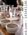 coffee cups prepared for the Q grader professional cupping session to evaluate aroma and flavor. Specialty coffee tasting setup in a cafe or roastery. 143441186