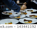 professional chef pouring brown sauce over stack meat decoration dishes during dinner food plating service in commercial restaurant kitchen. food service, hotel and restaurant cooking. 143441192