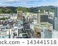Streetscape of Kobe's Chuo Ward with Mount Rokko in the background. 143441518
