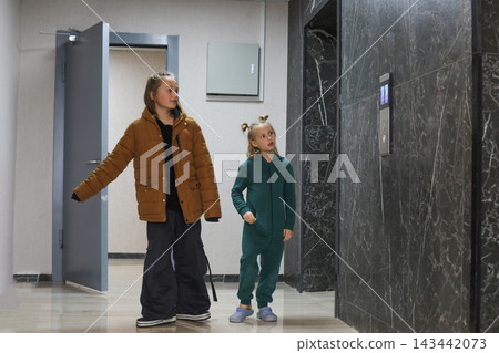 Pretty children getting ready to walk the dog 143442073