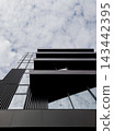 Low angle view of modern black building facade with glass balconies. 143442395