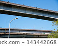 Low angle view of concrete elevated highway overpasses against clear blue sky 143442668