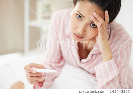 Woman, portrait and stressed in bedroom for pregnancy test with disappointed, sad emotions and frustrated. Female person, panic and nervous for fear of results, tension and worry for infertility Woman, portrait and stressed in bedroom for pregnancy test with disappointed, sad emotions and frustrated. Female person, panic and nervous for fear of results, tension and worry for infertility 143443305