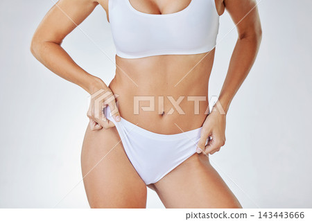 Body, underwear or woman on diet for abdomen, nutrition or natural wellness isolated on white studio background. Weight loss, health or stomach skin of slim model in panties for figure or dermatology Body, underwear or woman on diet for abdomen, nutrition or natural wellness isolated on white studio background. Weight loss, health or stomach skin of slim model in panties for figure or dermatology 143443666