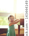 Girl, toddler and portrait by piano in home for musical development, learning and growth of motor skills or creativity. Child, instrument and happiness in house for entertainment, education and sound 143444149