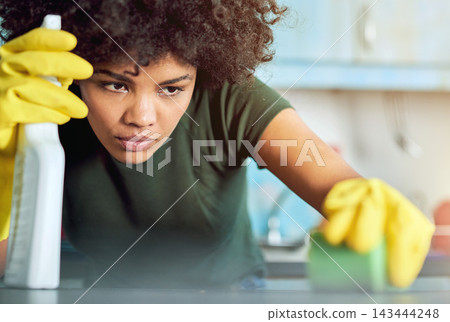 House, spray and woman with cleaning on counter for maintenance, hygiene and sanitation in kitchen. Person, detergent and bottle with gloves at home for bacteria, housekeeping and removal of dirt House, spray and woman with cleaning on counter for maintenance, hygiene and sanitation in kitchen. Person, detergent and bottle with gloves at home for bacteria, housekeeping and removal of dirt 143444248