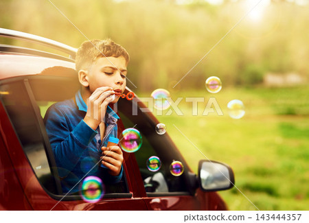 Blowing, bubbles and child for fun by window in nature, outdoor or countryside in Australia. Kid, boy and game in car for playing, freedom and childhood development of kid learning with soap toys Blowing, bubbles and child for fun by window in nature, outdoor or countryside in Australia. Kid, boy and game in car for playing, freedom and childhood development of kid learning with soap toys 143444357