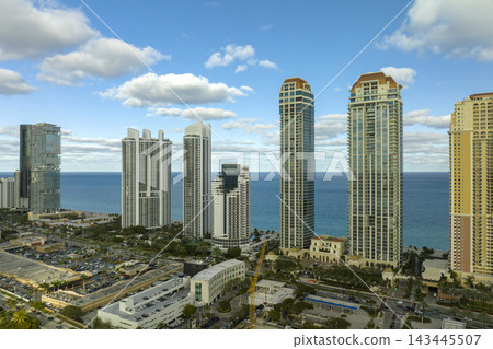 Expensive highrise hotels and condos on Atlantic ocean shore in Sunny Isles Beach city. American tourism infrastructure in southern Florida Expensive highrise hotels and condos on Atlantic ocean shore in Sunny Isles Beach city. American tourism infrastructure in southern Florida 143445507