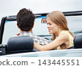 Couple, back and road trip in car for travel, love and journey with explore, adventure or vacation. People, happy and date in convertible with driving for fun summer, holiday or freedom outdoor 143445551