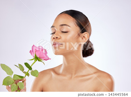 Rose, scent and woman in beauty with flower for healthy skincare on studio background. Floral, fragrance and girl smell perfume of plant blossom with natural glow on face from cosmetics in spring Rose, scent and woman in beauty with flower for healthy skincare on studio background. Floral, fragrance and girl smell perfume of plant blossom with natural glow on face from cosmetics in spring 143445564