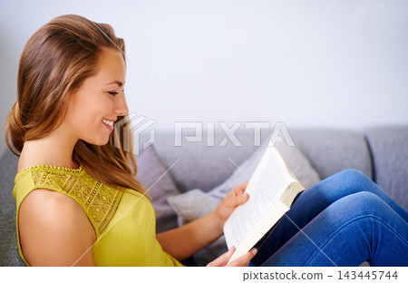 Woman, smile and calm with book on sofa for reading, studying poetry and learning of novel. Relax, home and female person with story in living room for fiction, knowledge and literature on weekend 143445744