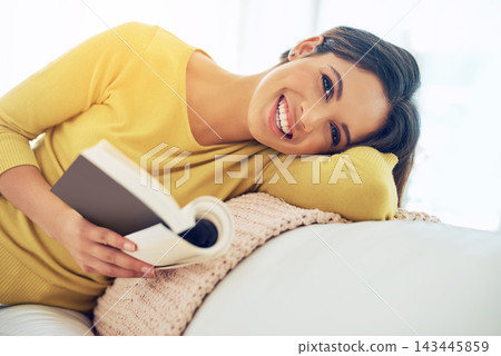 Woman, portrait and reading on sofa with book for relax, knowledge or literature in living room. Student, smile and gen z person with novel for story, information or studying on weekend in home Woman, portrait and reading on sofa with book for relax, knowledge or literature in living room. Student, smile and gen z person with novel for story, information or studying on weekend in home 143445859