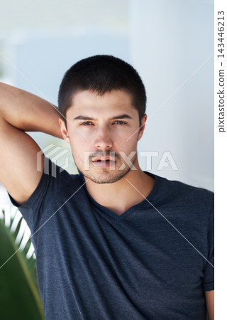 Confidence, serious and portrait of a man in home for relaxing, chill and pride in apartment. Sexy, flirting and face closeup of person with confident attitude, attractive and handsome in house 143446213
