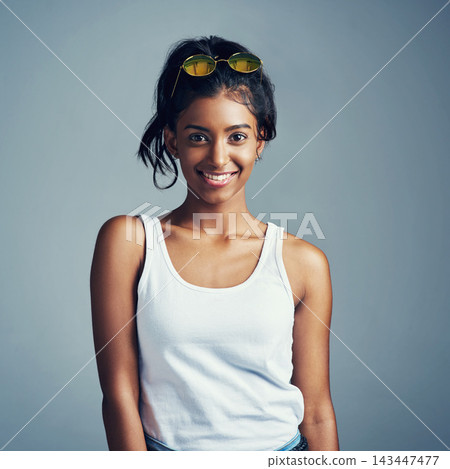 Portrait, Indian woman and happy with sunglasses in studio on grey background in casual, style and elegant. Girl, gen z and fashion with smile for clothes or street wear, outfit and confident Portrait, Indian woman and happy with sunglasses in studio on grey background in casual, style and elegant. Girl, gen z and fashion with smile for clothes or street wear, outfit and confident 143447477