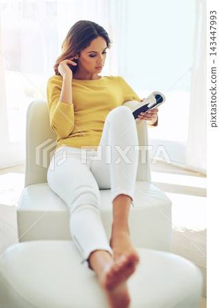 Book, woman and reading on sofa in living room on weekend for relax with story, entertainment and calm. Knowledge, creativity and personal development in house with fiction, fantasy and literature. Book, woman and reading on sofa in living room on weekend for relax with story, entertainment and calm. Knowledge, creativity and personal development in house with fiction, fantasy and literature. 143447993