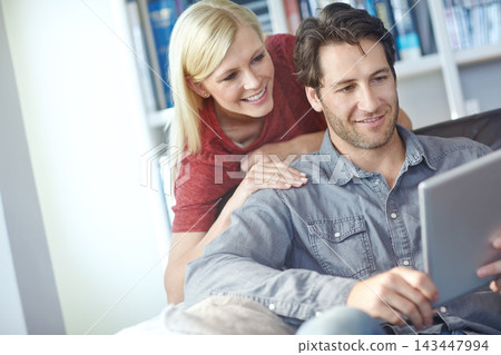 Happy, couple and home couch with tablet or relaxing online, people smile and internet browse together on social media. Web, scrolling and relationship bonding, networking and communication apartment Happy, couple and home couch with tablet or relaxing online, people smile and internet browse together on social media. Web, scrolling and relationship bonding, networking and communication apartment 143447994