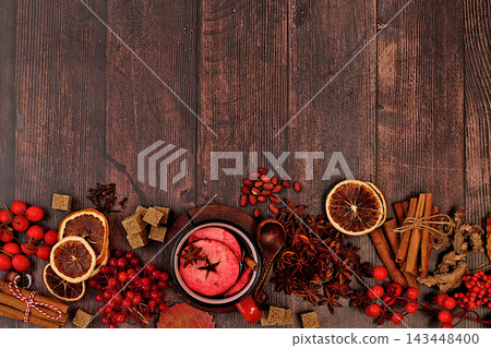 Autumn abstract composition featuring hot mulled wine, spices, burnt sugar, cloves, nuts, cinnamon, star anise, rowan berries, and rose hips, still life,Thanksgiving concept, seasonal background Autumn abstract composition featuring hot mulled wine, spices, burnt sugar, cloves, nuts, cinnamon, star anise, rowan berries, and rose hips, still life,Thanksgiving concept, seasonal background 143448400