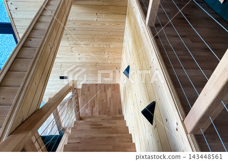 Wooden staircase in modern house with minimalist design and natural light 143448561