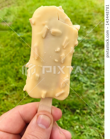 Delicious ice cream treat enjoyed on a sunny outdoor day Delicious ice cream treat enjoyed on a sunny outdoor day 143448781
