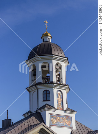 Minsk, Belarus - October 5, 2026: Pokrovsky Temple bell tower and memorial cross 143448903