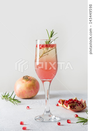 Pomegranate Christmas cocktail with rosemary, champagne. Xmas drink. Pomegranate Christmas cocktail with rosemary, champagne. Xmas drink. 143449598