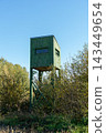 Green wooden hunting tower on stilts 143449654