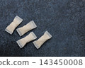 Snus pouches arranged on a textured surface ready for use during a casual gathering with friends 143450008
