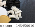 Snus pouches and nicotine pads arranged on a surface with different colored containers for storage and usage 143450010