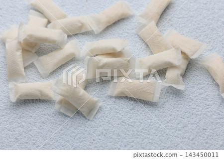 Snus pouches arranged on a white surface showing the different shapes and sizes during a casual indoor scene Snus pouches arranged on a white surface showing the different shapes and sizes during a casual indoor scene 143450011