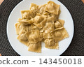 Homemade ravioli served on a white plate for a delicious meal 143450018