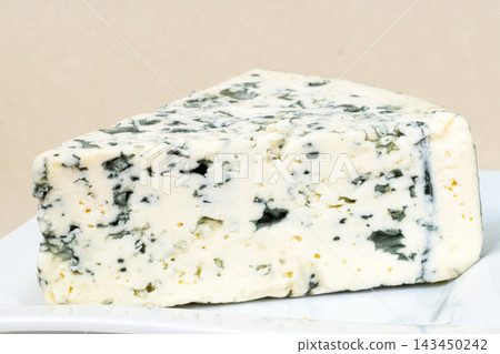 A piece of blue cheese on a plate A piece of blue cheese on a plate 143450242