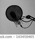 Professional microphone with mask filter for voice recording against sound absorbing panels in a recording studio  143450465