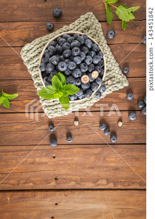 Fresh blueberries in bowl on rustic wooden background Fresh blueberries in bowl on rustic wooden background 143451842