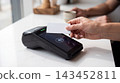 Customer making a contactless payment with a credit card at a retail terminal transaction contactless checkout purchase business merchant customer cashless commerce technology 143452811