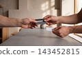 Person handing a credit card to a cashier for payment in a modern coffee shop with transaction customer business purchase shopping terminal commerce checkout exchange electronic consumer 143452815
