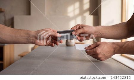 Person handing a credit card to a cashier for payment in a modern coffee shop with transaction customer business purchase shopping terminal commerce checkout exchange electronic consumer Person handing a credit card to a cashier for payment in a modern coffee shop with transaction customer business purchase shopping terminal commerce checkout exchange electronic consumer 143452815