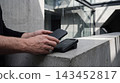 Person making a contactless payment using a mobile phone at a terminal with contactless terminal technology transaction business purchase checkout electronic consumer wireless commerce 143452817