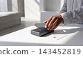 Person using a smartphone for contactless payment on a terminal with contactless smartphone terminal technology transaction business purchase checkout electronic consumer commerce spending 143452819