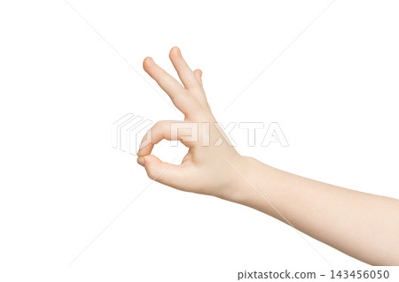 Kid hand showing OK sign isolated on white background. Close-up of positive gesture, like, agreement, accept concept 143456050