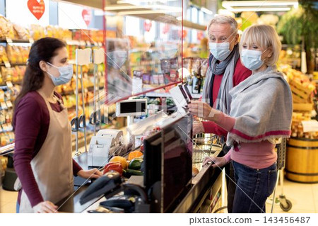 Happy Elderly Caucasian Couple Selecting Fresh Fruits And Vegetables At Supermarket Checkout, Enjoying Shopping Experience Together, Conveying Love And Affection In A Casual Setting. Business Concept. Happy Elderly Caucasian Couple Selecting Fresh Fruits And Vegetables At Supermarket Checkout, Enjoying Shopping Experience Together, Conveying Love And Affection In A Casual Setting. Business Concept. 143456487