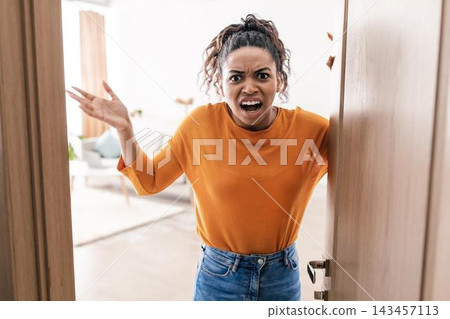 Frustrated Black Woman Standing At Doorway, Expressing Displeasure, Having Argument Or Disagreement, In Home Environment. Emotional Response Indicates Unwelcome Situation, Lifestyle Concept. 143457113